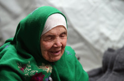 105-year old Afghan regugee Bibihal Uzbeki from Kunduz, Afghanistan, rests in Croatia's main refugee camp at Opatovac, Croatia, near the border with Serbia, Tuesday, Oct. 27, 2015.  Centenarian Bibihal Uzbeki, crossed into Croatia on a stretcher from Serbia with a large group of refugees, including her son and several other relatives, among tens of thousands who have traveled across continents, fleeing war and poverty to search for a happier, safer future in Europe. (AP Photo/Marjan Vucetic)