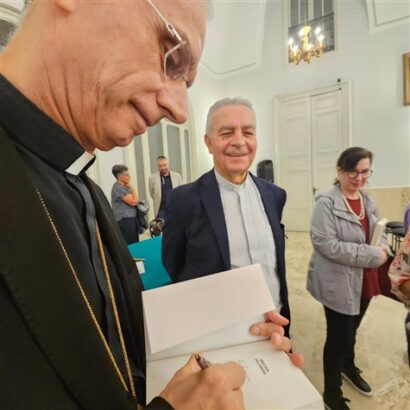 Monsignor Raspanti firma copia del suo libro su santa caterina